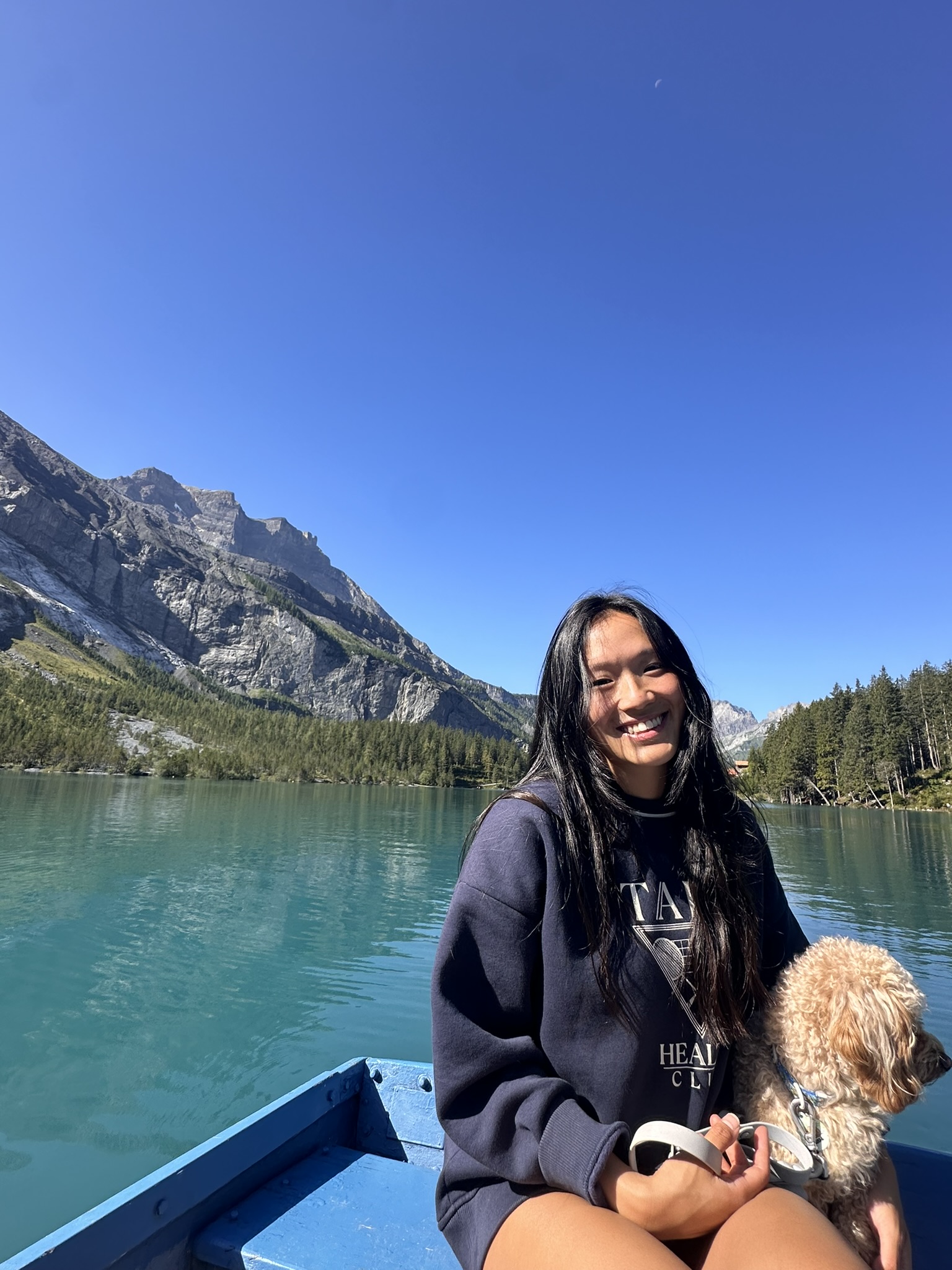 A picture of myself and Simba  (pet dog) on a boat on Oeschinen lake